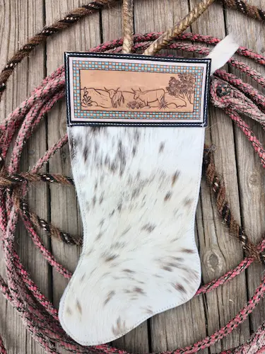 Handtooled leather stocking: long-horns on the desert
